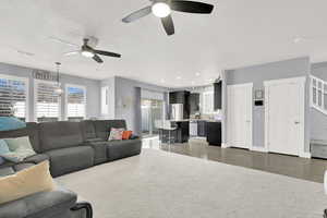 Living room featuring a textured ceiling and ceiling fan