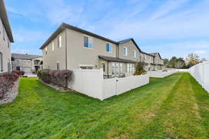 Rear view of property with a lawn