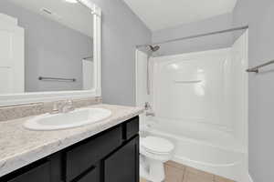 2nd Floor Full bathroom with tile floors, vanity, toilet, and tub / shower combination