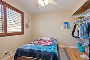 Bedroom featuring ceiling fan and hardwood / wood-style floors