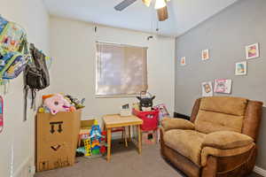 Recreation room featuring carpet flooring and ceiling fan