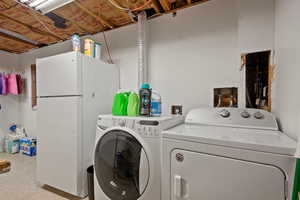 Laundry room featuring washing machine and clothes dryer