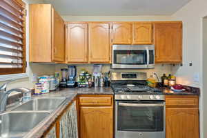 Kitchen featuring sink and appliances with stainless steel finishes