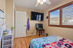 Bedroom featuring ceiling fan and light wood-type flooring