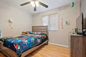 Bedroom featuring ceiling fan and hardwood / wood-style floors