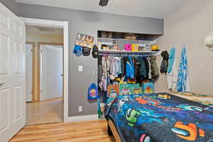 Bedroom with hardwood / wood-style floors and ceiling fan