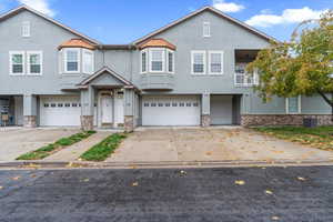 Front of unit with two car garage and private balcony