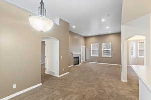 View from dining area. Large open concept with vaulted ceilings and gas fireplace. Glass door to a private balcony