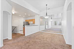 Large dining area with room for a large table and barstools for kitchen bar dining