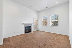 Spacious living area with cozy gas fireplace and access to a private balcony