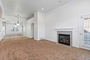 Spacious living area with cozy gas fireplace and access to a private balcony