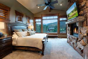 Bedroom featuring light colored carpet, ceiling fan, and lofted ceiling