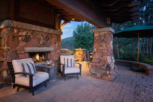 View of patio featuring an outdoor stone fireplace