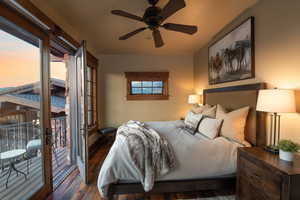 Bedroom featuring dark hardwood / wood-style floors, ceiling fan, and access to exterior