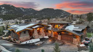 View of front of house with a mountain view, a balcony, and a garage