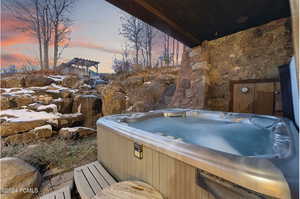 Deck at dusk with a hot tub