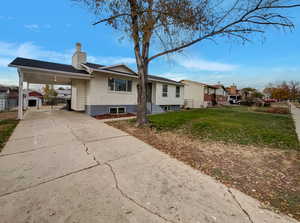 View of front of house featuring a front yard and a carport