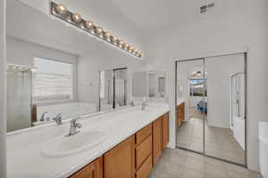 Bathroom with ceiling fan, tile patterned flooring, vanity, and independent shower and bath