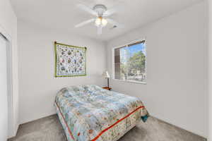 Bedroom featuring ceiling fan and carpet floors