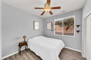 Bedroom featuring ceiling fan and hardwood / wood-style flooring