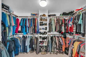 Walk in closet featuring carpet flooring