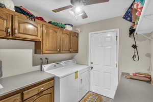 Clothes washing area with cabinets and washing machine and dryer