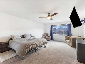 Bedroom with ceiling fan and light colored carpet