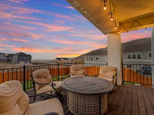 Deck at dusk featuring a mountain view