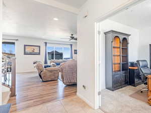 Home office with light hardwood / wood-style floors and ceiling fan