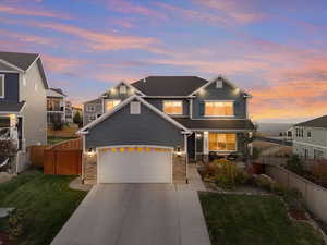 Craftsman house with a lawn and a garage