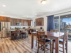 Dining space with a textured ceiling and light wood-type flooring