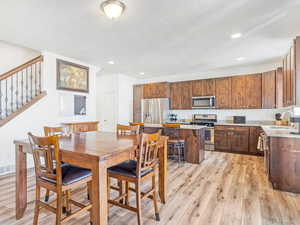 Dining room featuring a textured ceiling, light hardwood / wood-style floors, and sink