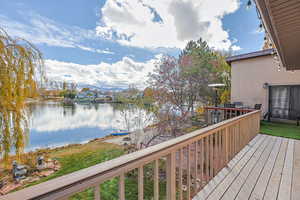 Wooden deck featuring a water and mountain view