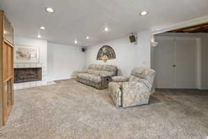 Living room with carpet flooring and a fireplace