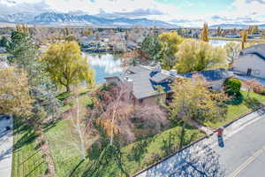 Drone / aerial view featuring a water and mountain view