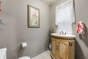 Bathroom featuring plenty of natural light, vanity, a textured ceiling, and tile patterned flooring