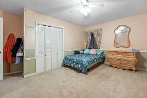 Bedroom with carpet, a closet, and ceiling fan