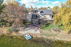 Back of property with a deck with water view