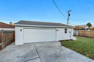 Garage featuring a yard