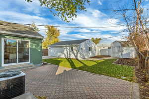 View of patio featuring a storage shed and central air condition unit