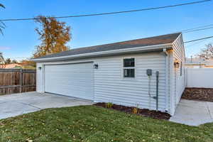 Garage featuring a lawn