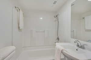 Bathroom featuring shower / bathtub combination and sink