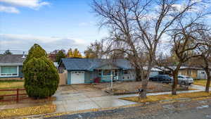 View of front of property featuring a porch and a garage