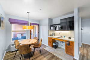 Dining room with sink and light hardwood / wood-style floors