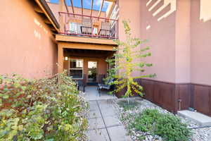 Doorway to property featuring a patio and a balcony