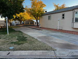 View of side of property featuring a yard