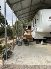 View of parking with a carport