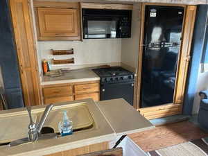 Kitchen featuring black appliances