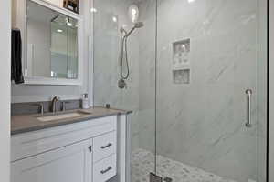 Bathroom featuring vanity and an enclosed shower