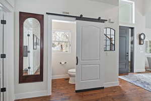 Bathroom with hardwood / wood-style floors and toilet